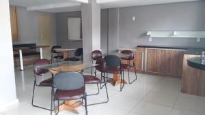 a dining room with a table and chairs at Hotel Gravataí Express in Gravataí