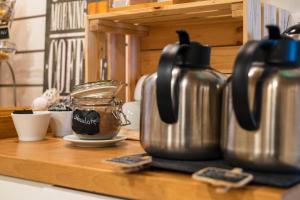 a counter top with two kettles and a jar of coffee at Casa Azul Sagres - Rooms & Apartments in Sagres