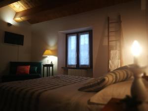 Posteľ alebo postele v izbe v ubytovaní Ca' Le Erbe
