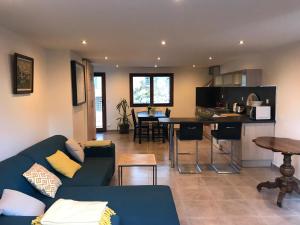 a living room and kitchen with a couch and a table at Chez Albert in Aiguebelette-le-Lac +15 photos