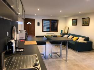 a kitchen and living room with a couch and a table at Chez Albert in Aiguebelette-le-Lac