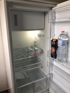 an empty refrigerator with water bottles in it at K House 5* Apartments in Kaufungen