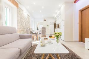 a living room with a couch and a table at Apartman Grgur in Split