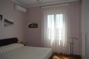 a bedroom with a bed and a large window at ilGirasole b&b in Rapallo