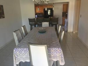 a dining room with a table and chairs and a kitchen at 82-10SW 135AV in Miami