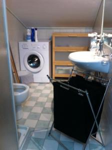 a bathroom with a sink and a washing machine at Casa Iolanda in Sorrento