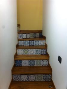 a staircase with blue and white tiles on it at Casa Iolanda in Sorrento