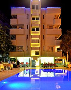 a hotel with a swimming pool in front of a building at Rumana Hotel in Anamur