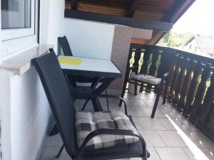 a table and chairs sitting on a balcony at Guesthouse Tomas in Čatrnja