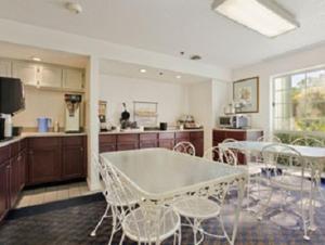 a kitchen and dining room with a table and chairs at Super 8 by Wyndham Oroville in Oroville