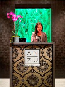 a woman is standing behind a podium with pink flowers at Hotel Nikko San Francisco in San Francisco