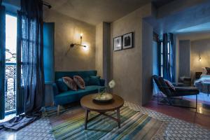 a living room filled with furniture and a large window at The Riad - Adults Only in Tarifa