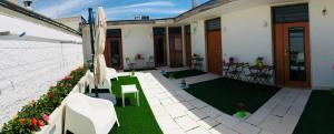 a house with a patio with a green lawn at Truly Apulia in Bari