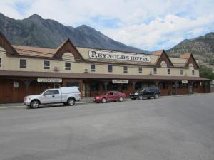 a large building with cars parked in front of it at Reynolds Hotel in Lillooet
