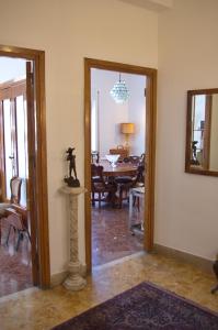 a living room with a table and a dining room at Olivarooms in Palermo