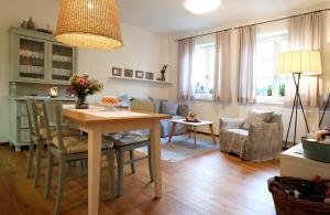 a kitchen and living room with a table and chairs at Auszeit in Apetlon