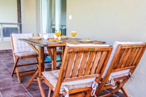 a dining room table with chairs and glasses of wine at Comfort Luxury Maisonette in Thessaloniki