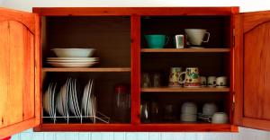 a wooden cabinet with plates and dishes in it at Lefteris Studios in Lefokastro +19 photos