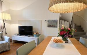 a dining room with a table and a television at Auszeit in Apetlon