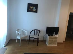 a room with two chairs and a television and a desk at U Ferka in Lemešany