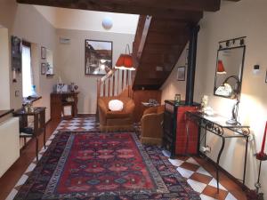 a living room with a staircase and a rug at B&B Da Time in Vittorio Veneto