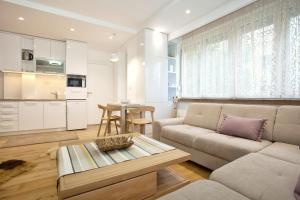 a living room with a couch and a table at HostGost Selected Suites - Skadarlija Square in Belgrade
