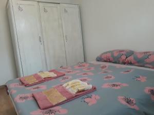 a bedroom with a bed with two towels on it at Apartman Dijelovi in Bijeljina