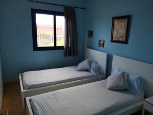 A bed or beds in a room at Bahía Meloneras