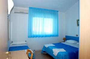 Postel nebo postele na pokoji v ubytování Long Beach Village Residence sul mare spiaggia privata inclusa