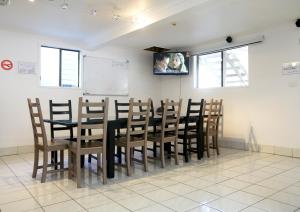 a room with a table and chairs in a classroom at Gonow Family Backpackers Hostel in Brisbane