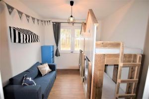 a living room with a couch and a bunk bed at Ferienwohnung Familie Anker - toll für Groß und Klein! in Hohwacht