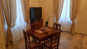 a dining room with a table and a television at La Salita B&B in Viterbo