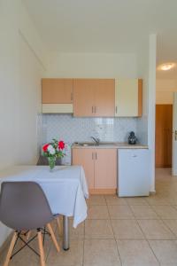 a kitchen with a table with a vase of flowers on it at Kassiani Studios in Plakias