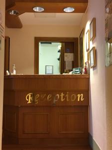 a reception desk with a sign that reads reception at Zum Winzermännle in Würzburg