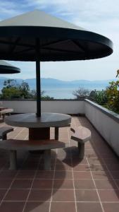 a picnic table with an umbrella on a roof at Hotel Casa don Pedro in San Pedro La Laguna