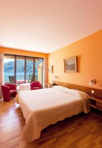 a hotel room with a bed and a large window at Swiss Lodge Nassa Garni in Lugano