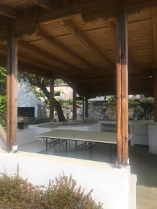 a pavilion with tables under a wooden roof at Zeusplace Seaside Home private beach and parking in Plaka Litochorou
