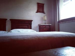 a bedroom with a bed and a window at Casa della Fornace in San Vito al Torre