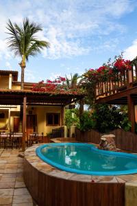 a swimming pool in the middle of a patio with a house at Pousada Sahara in Jericoacoara