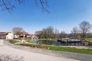 a river with a dock in a park at Ferienhaus vom Bahratal in Hausen