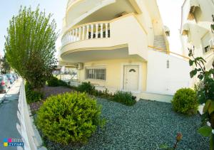 a house with a balcony on the side of it at Evaggelia Design Suite in Nea Peramos