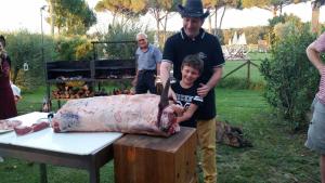 a man and a young boy standing next to a large animal at La Fattoria di Tirrenia in Tirrenia
