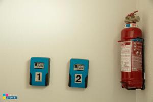 a fire hydrant and two thermometers on a wall at The L Studio in Nea Peramos