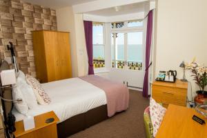 a bedroom with a bed and a dresser at The Clifton in Shanklin