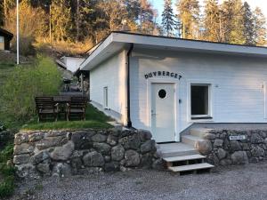 a small white building with a sign on it at Duvberget in Kolmården