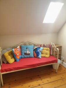a bench with pillows on it in a room at The Herring Queen in Eyemouth +16 photos