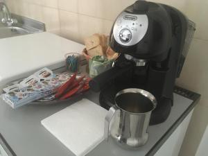 a coffee maker sitting on a counter next to a cup at James house in Teramo