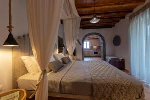 a bedroom with a bed in a room with a ceiling at Madalena's Summer House in Adamantas
