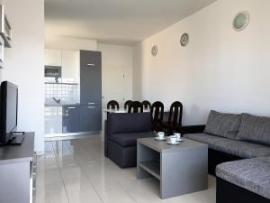a living room with a couch and a table at Apartment FERAL Novalja in Novalja