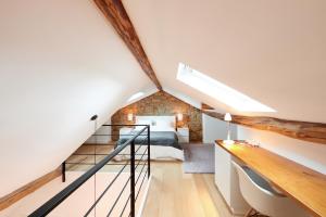 a loft bedroom with a bed and a staircase at CityStudios in Luxembourg